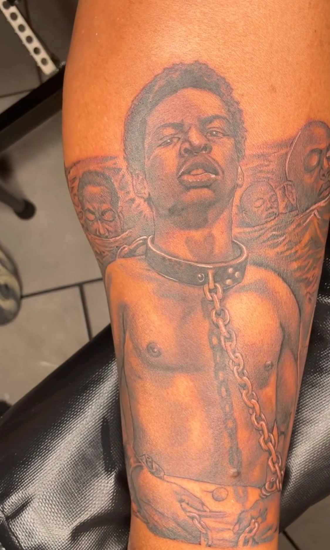 Chained figure tattoo symbolizing struggle and endurance